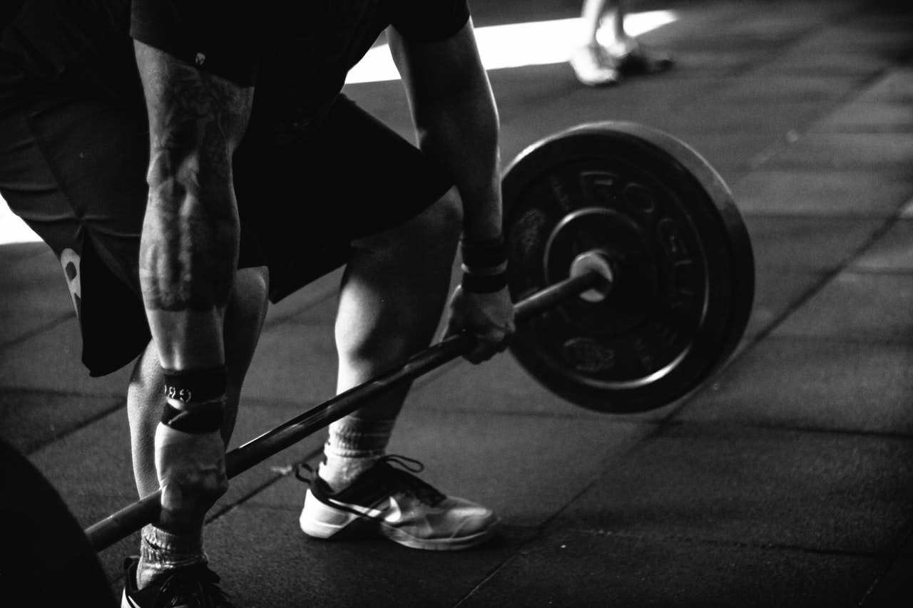 Man lifting weights to grow as a person