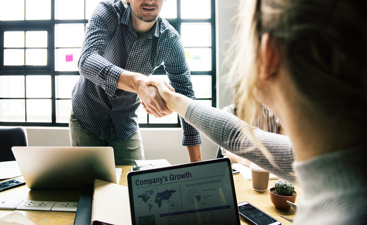 male and female coworkers shaking hands